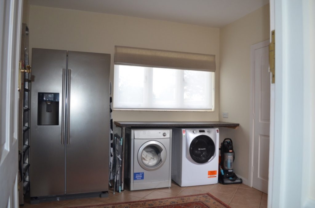 Utility room showing fridge, tumble dryer and washing machine
